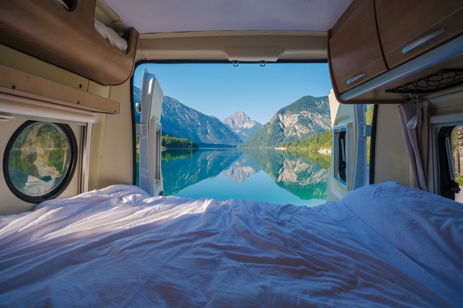 Awakening to breathtaking views of Plansee Austria from a cozy campervan at dawn
